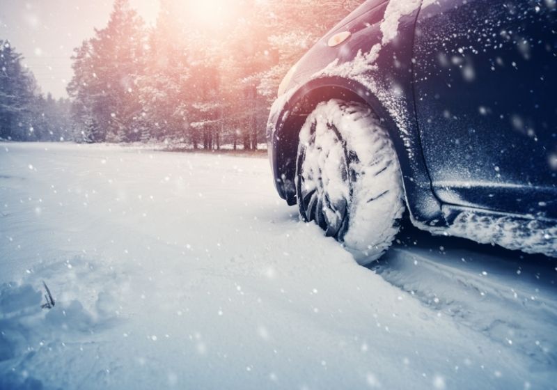 Car tires on winter road covered with snow | Winterize Car | 13 Ways on How to Winterize a Car