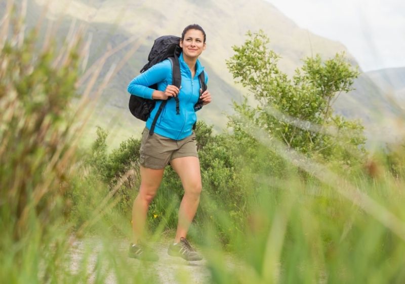 Female hiker with backpack walking and smiling | Homemade Wanderlust Gear List | XX Things You Should Have in Your Appalachian Trail Gear List