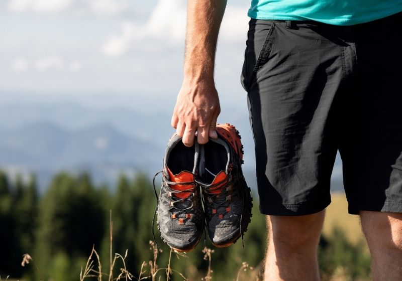Man holding sneakers on mountains | Homemade Wanderlust Gear List | XX Things You Should Have in Your Appalachian Trail Gear List