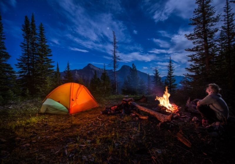 Man looking up at stars next to campfire | Homemade Wanderlust Gear List | XX Things You Should Have in Your Appalachian Trail Gear List
