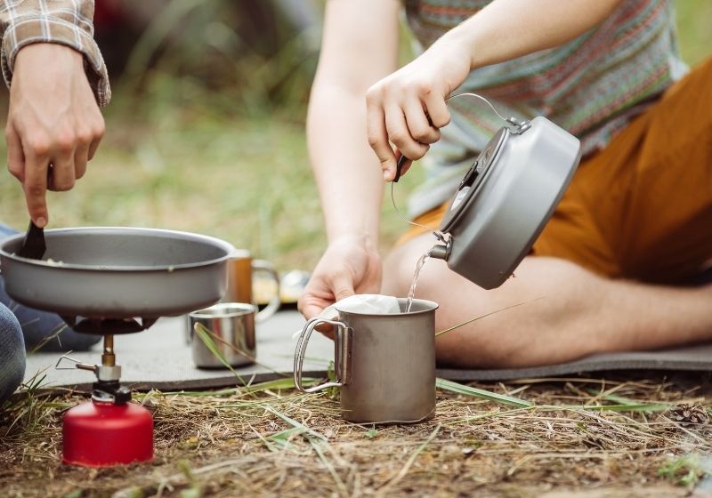 Two fellow campers making tea and preparing food | Homemade Wanderlust Gear List | XX Things You Should Have in Your Appalachian Trail Gear List