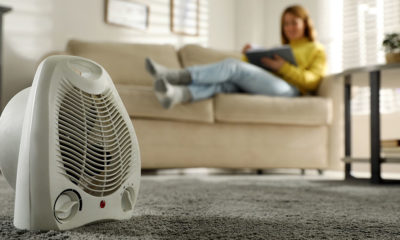 Woman reading book in living room, focus on electric fan heater | Battery Operated Heater| Best Battery Powered Heaters of 2022 Reviews and Buying Guide | Featured