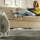 Woman reading book in living room, focus on electric fan heater | Battery Operated Heater| Best Battery Powered Heaters of 2022 Reviews and Buying Guide | Featured