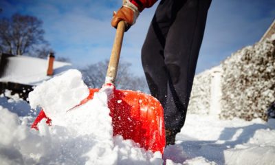 Man with snow shovel cleans sidewalks in winter homemade ice melt | Homemade Ice Melt | The Easy Way to Melt Ice You Never Knew About (It’s Not Salt!) | Featured
