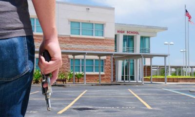 A young man with a pistol gun is standing in front of a high school preparing to commit a crime | Public Mass Shooting, Prevent Yourself From Becoming The Victim | featured