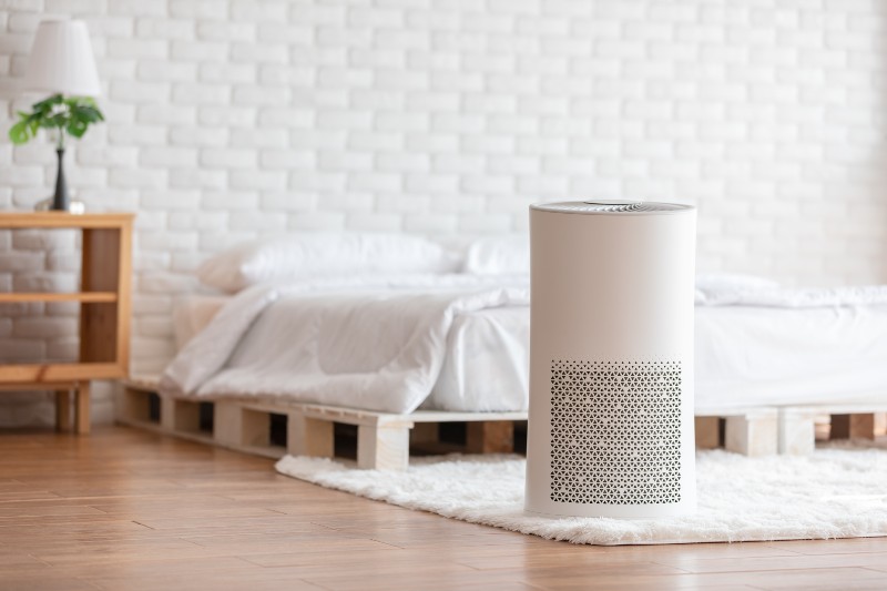 Air purifier in cozy white bedroom for filter and cleaning removing dust | Air Pollution