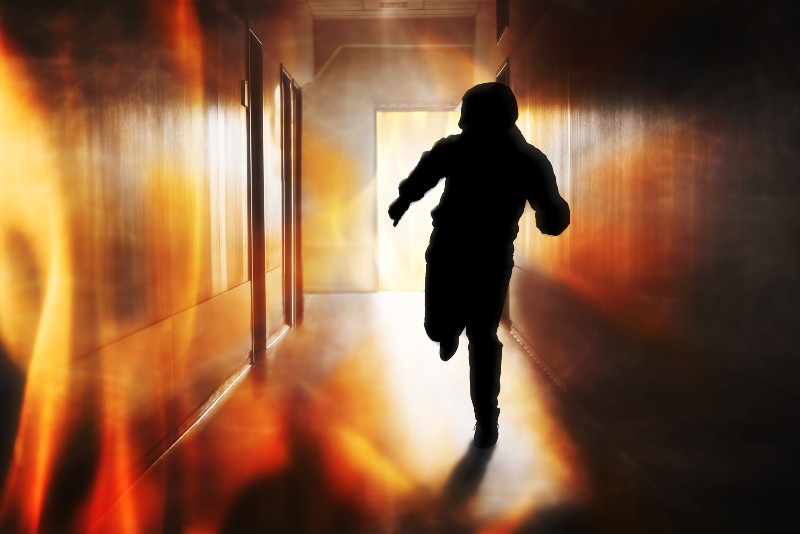 Silhouette Of Person Running Out Of Fire Escape | What to Do if You Get Caught in a Fire Survival Strategy | Survival Strategies