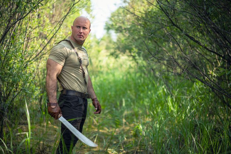 adventurer-man-machete-green-forest-concept best survival machetes