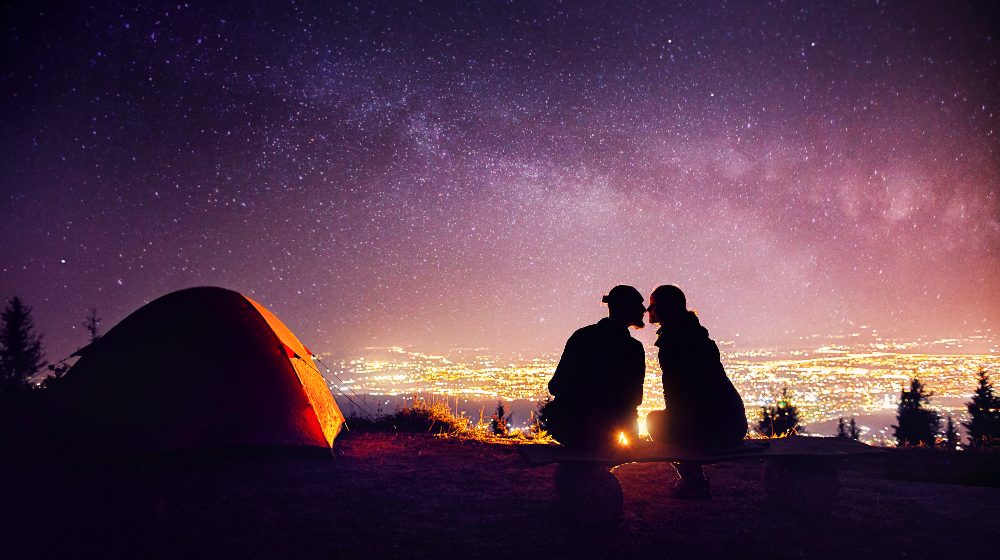 Happy Couple in Silhouette Kissing near Campfire | Valentines Day Camping | Featured
