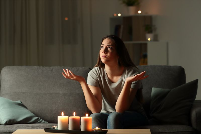 woman-complaining-during-blackout-sitting-on How to Keep Warm Without Electricity 
