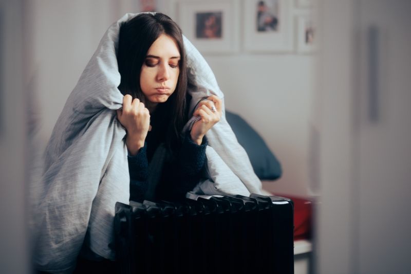 woman-sitting-next-heater-blanket-on how to prepare for power outage in winter