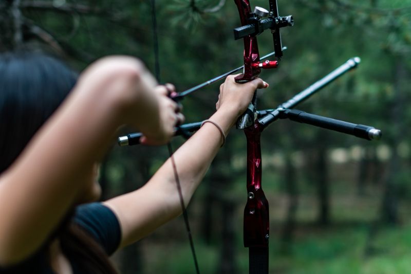 closeup shot woman hunter aiming bow Bow-Huntress 