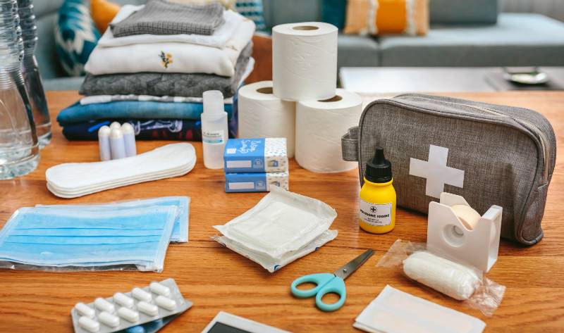 Emergency backpack equipment with first aid kit organized on the table in the living room | Bug-Out Medicine | Dr. Bones & Nurse Amy
