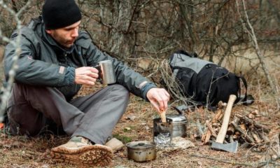man relaxing in the forest camping, near the wood | Top 10 Bushcraft Must Haves | Featured