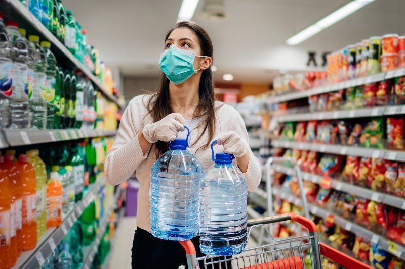 Woman Wearing Face Mask Buying Bottled Water in Supermarket | Ukraine Invasion 2022