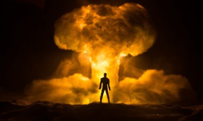 How to Survive a Nuclear War | Explosion of nuclear bomb | Silhouette of a person against giant mushroom cloud of atomic explosion.