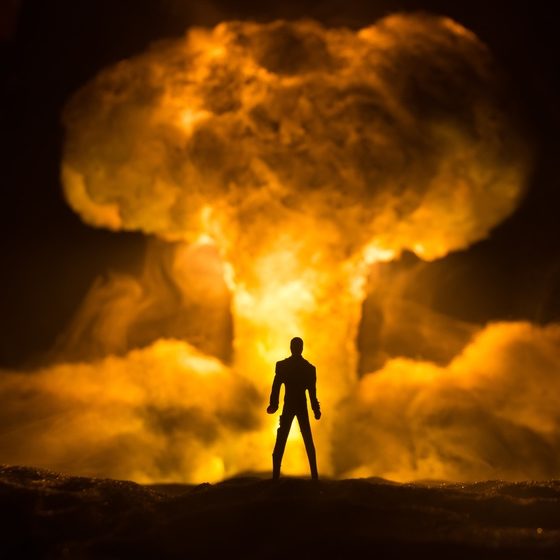 How to Survive a Nuclear War | Explosion of nuclear bomb | Silhouette of a person against giant mushroom cloud of atomic explosion.