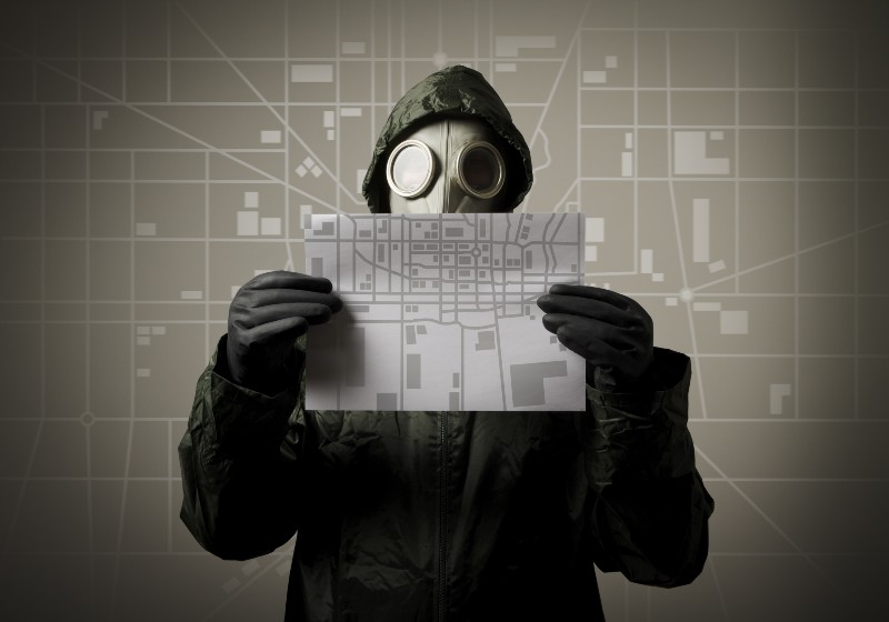 How to Survive A Nuclear War | Man wearing a gas mask on his face and holding a city map | Step One: Have a Nuclear War Survival Plan