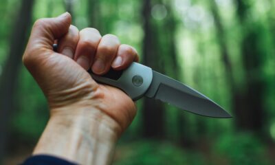 person holding gray and black Wilderness Survival Knives