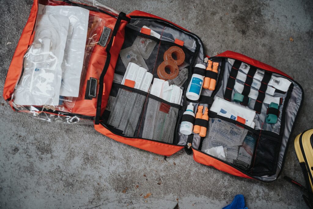First Aid Kit orange white and black bag