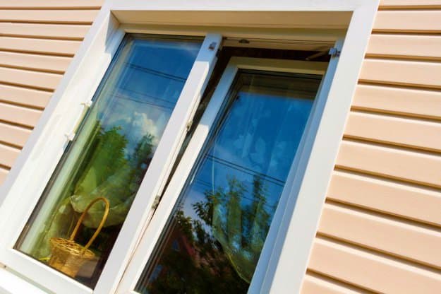 Perfect Spots To Set Up Your Home Security Cameras Beige plastic siding and windows home security cameras getty 1