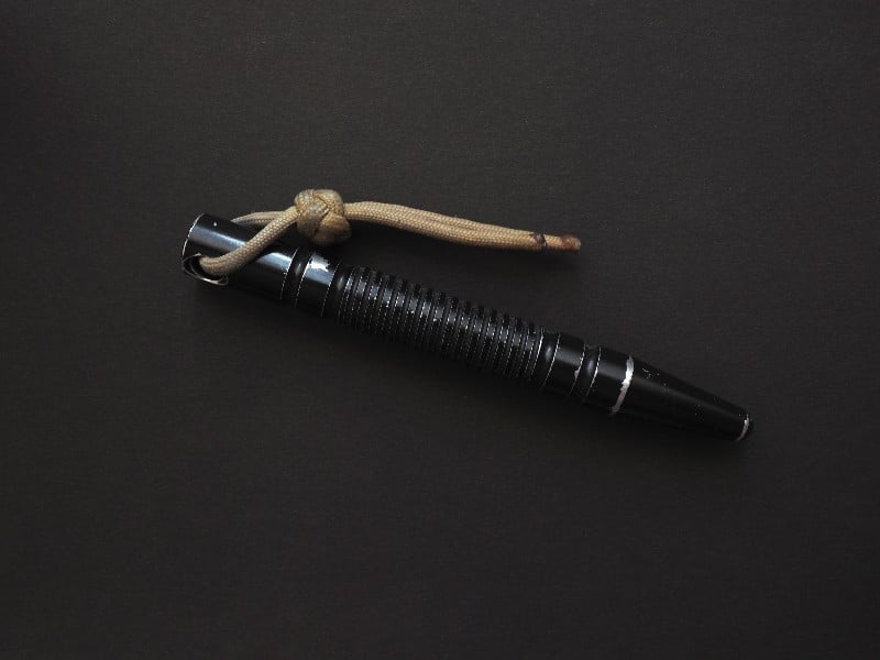 Kubotan self defense device on a black background kubotan ss 1