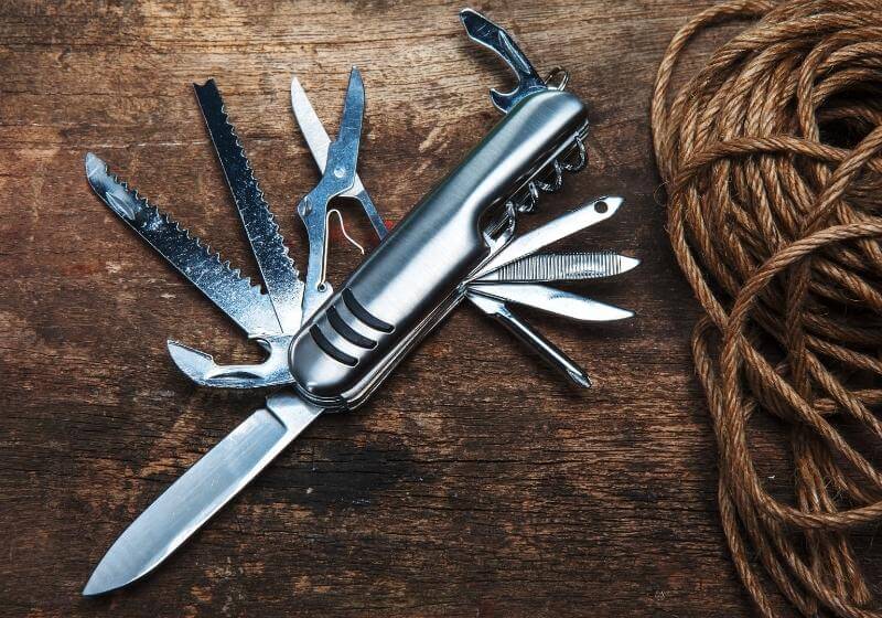 Top 16 Items to Have in Your EDC Kit Multipurpose pocket knife on wood Best multi tools SS 1