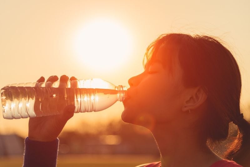 female drinking bottle water closeup woman Heat Stroke Symptoms SS 1