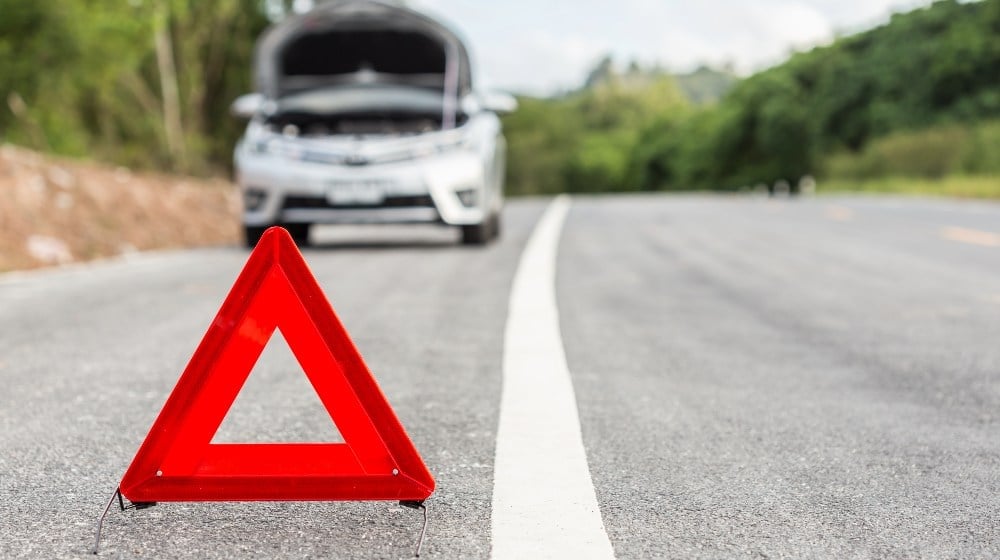7 Survival Gear Items That Can Fit In Your Glove Box (2026) red emergency sign and broken car on the road car emergency kit ss featured 1