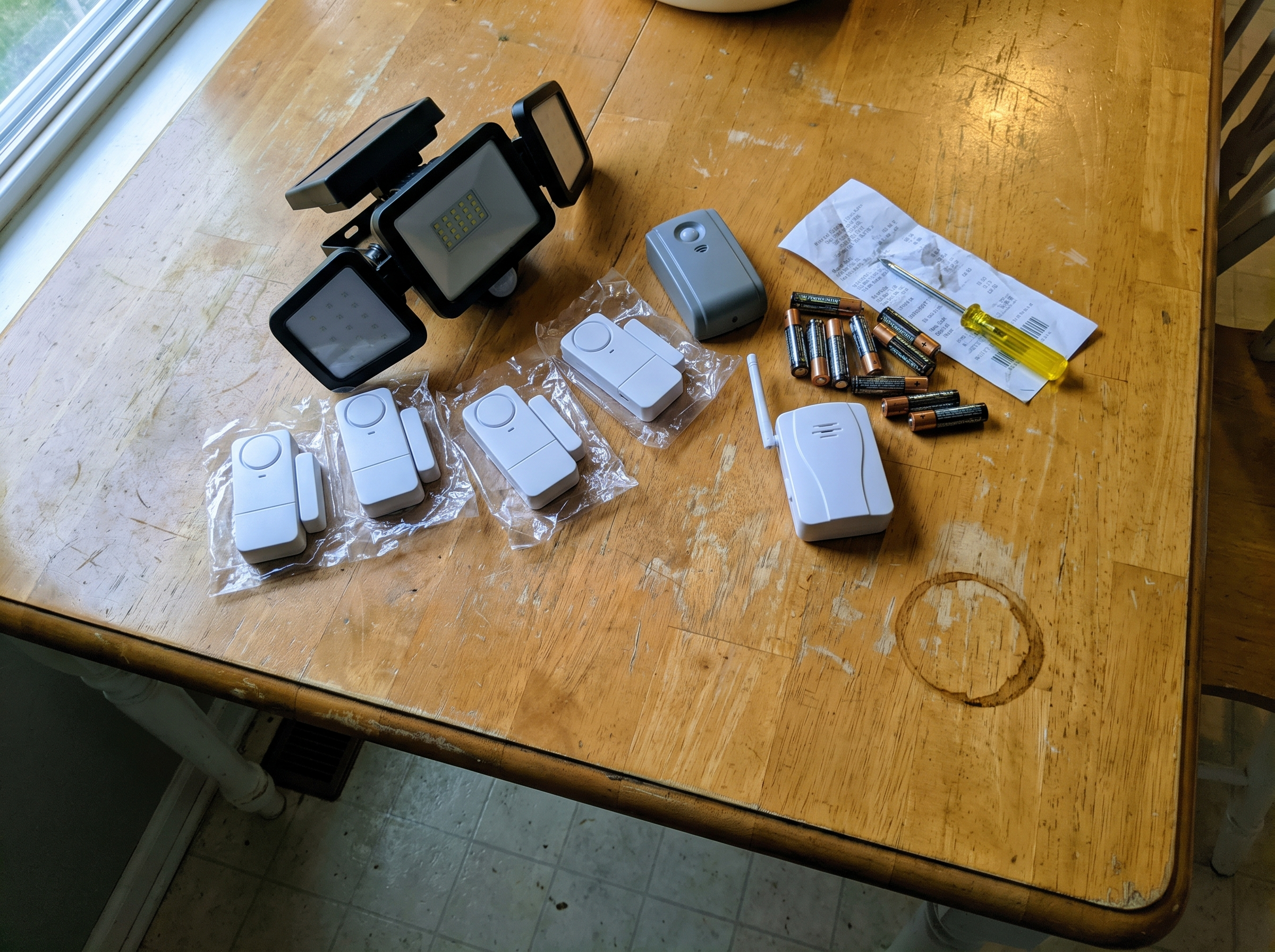 Home Security That Works Without Power or WiFi A sub-$200 home detection layer laid out on a kitchen table